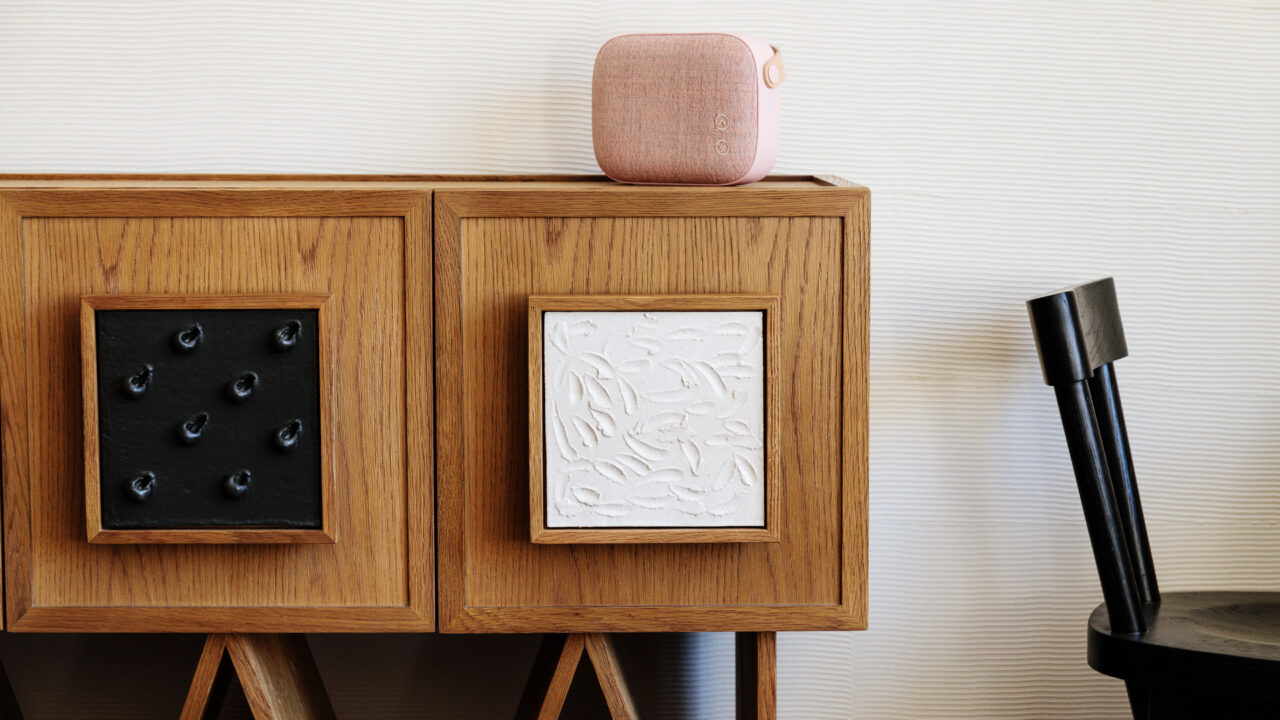 Modern wooden cabinet with artistic panel details and minimalist decor accents