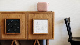 Modern wooden cabinet with artistic panel details and minimalist decor accents