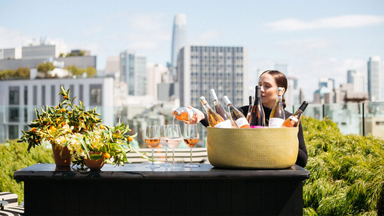 Rooftop wine tasting setup with city skyline views and outdoor event service