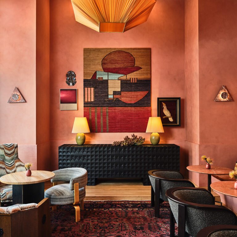 Elegant hotel lounge with contemporary artwork, warm lighting, and designer seating