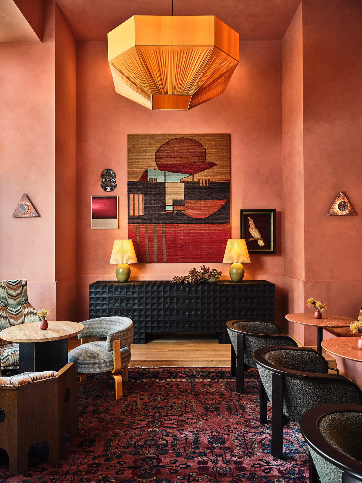 Elegant hotel lounge with contemporary artwork, warm lighting, and designer seating