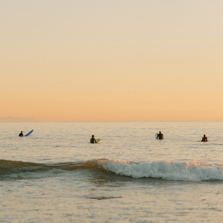 People are surfing on the ocean waves.