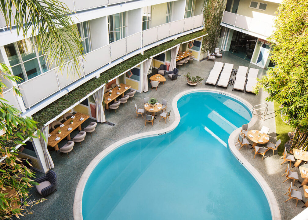 Courtyard pool with loungers and cabana seating in a relaxed, modern setting.