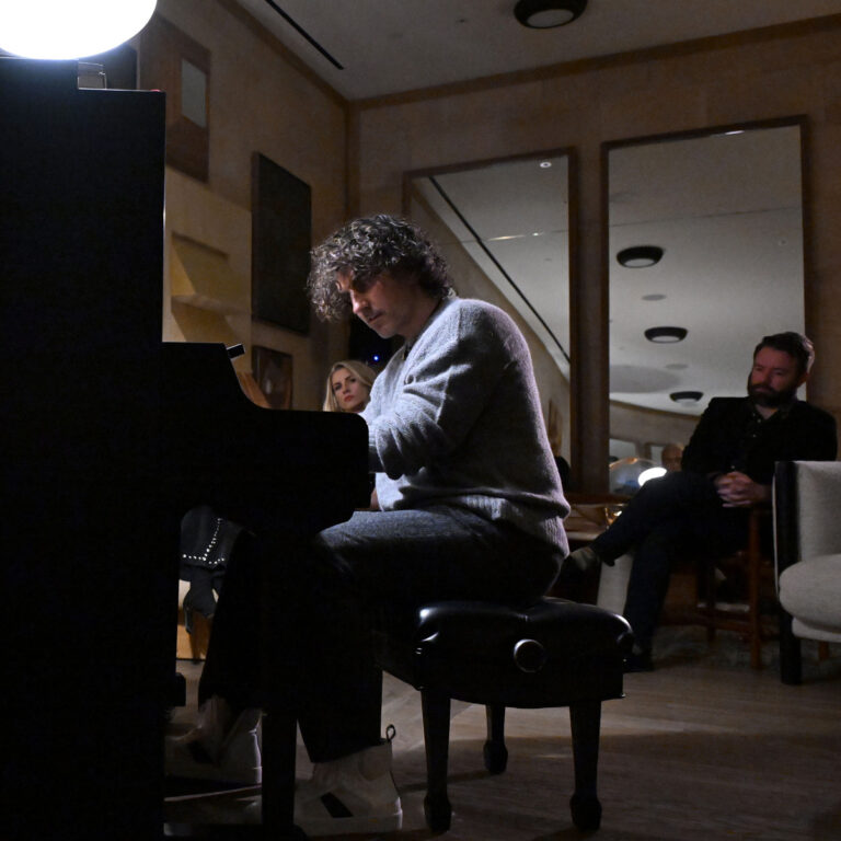 Man playing piano during an intimate indoor live music performance