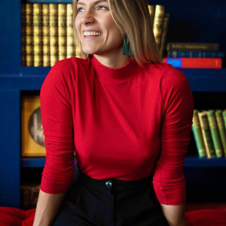 Bright, candid moment-bold red styling with a relaxed, joyful vibe.