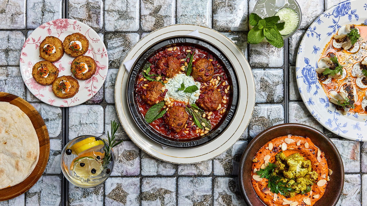 Various delicious dishes are presented on plates arranged neatly on the table.