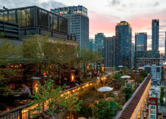 Rooftop dining terrace overlooking the Downtown Los Angeles skyline at sunset