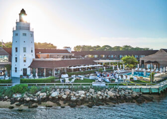Waterfront resort with iconic Montauk Yacht Club lighthouse and vibrant poolside scene.