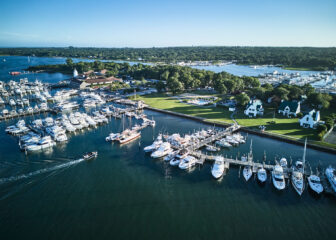 Scenic marina with yachts, waterfront homes, and lush surroundings in Montauk Yacht Club
