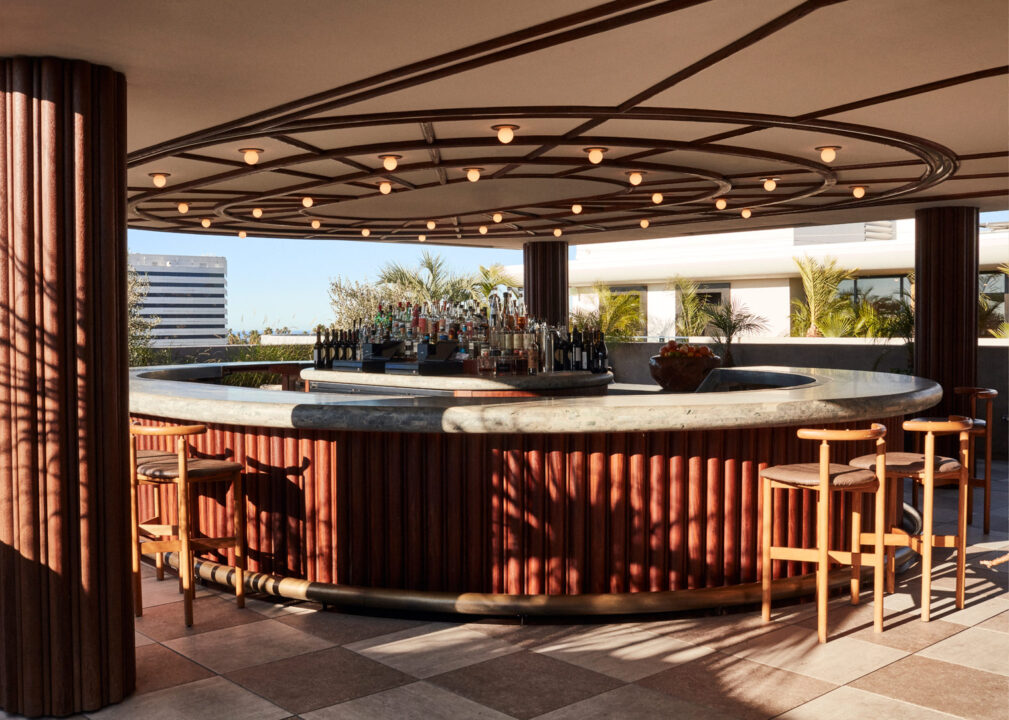 Modern rooftop bar with circular seating and open air city views