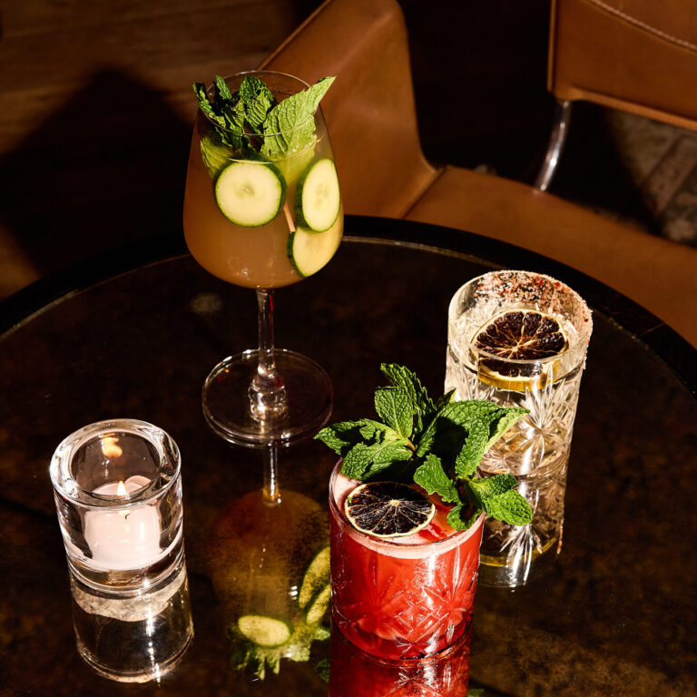 Colorful cocktails on a candlelit lounge table