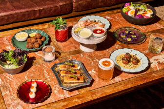 Upscale table with assorted small plates and cocktails