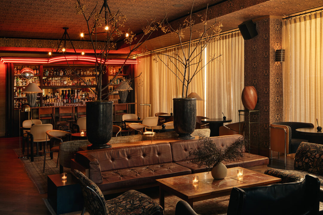Moody lounge bar with warm lighting and plush seating