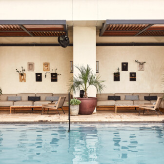 Stylish poolside lounge with seating and greenery