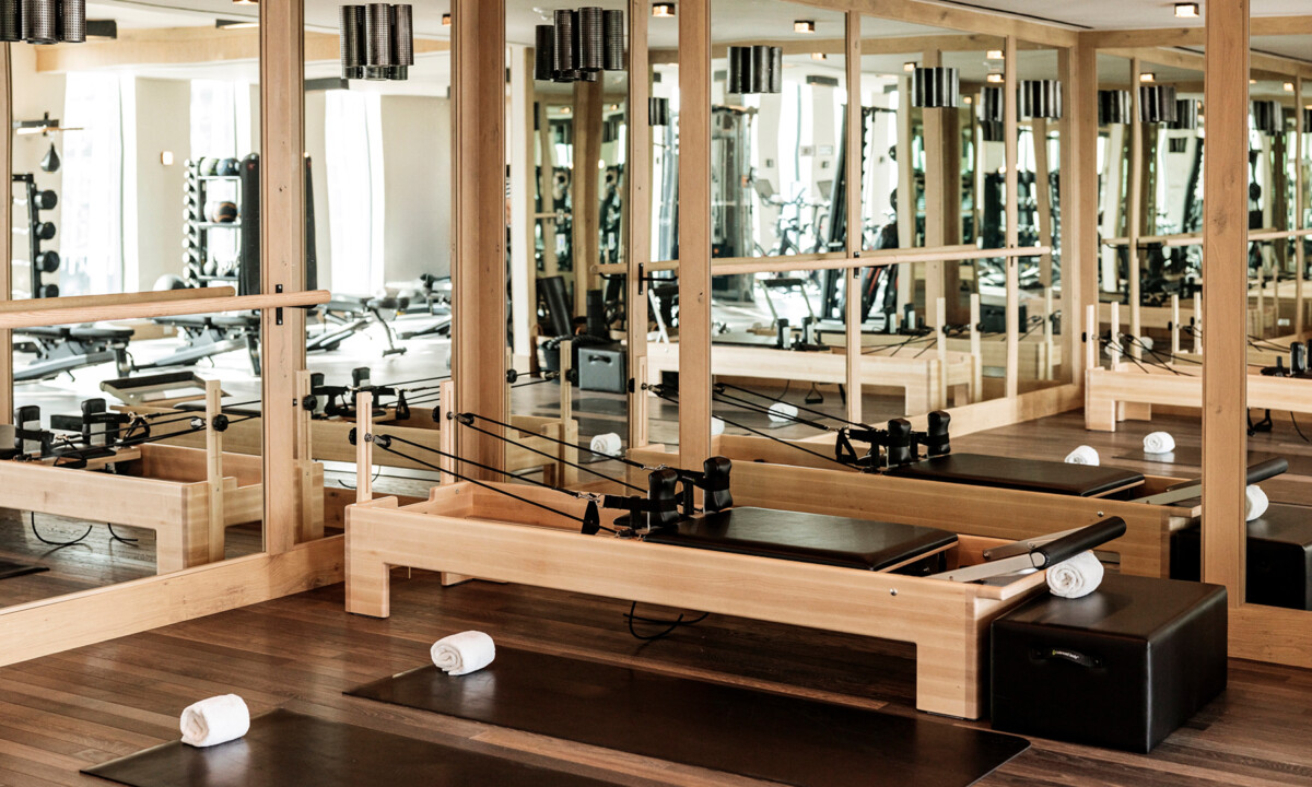 Pilates studio with reformer machines and mirrors