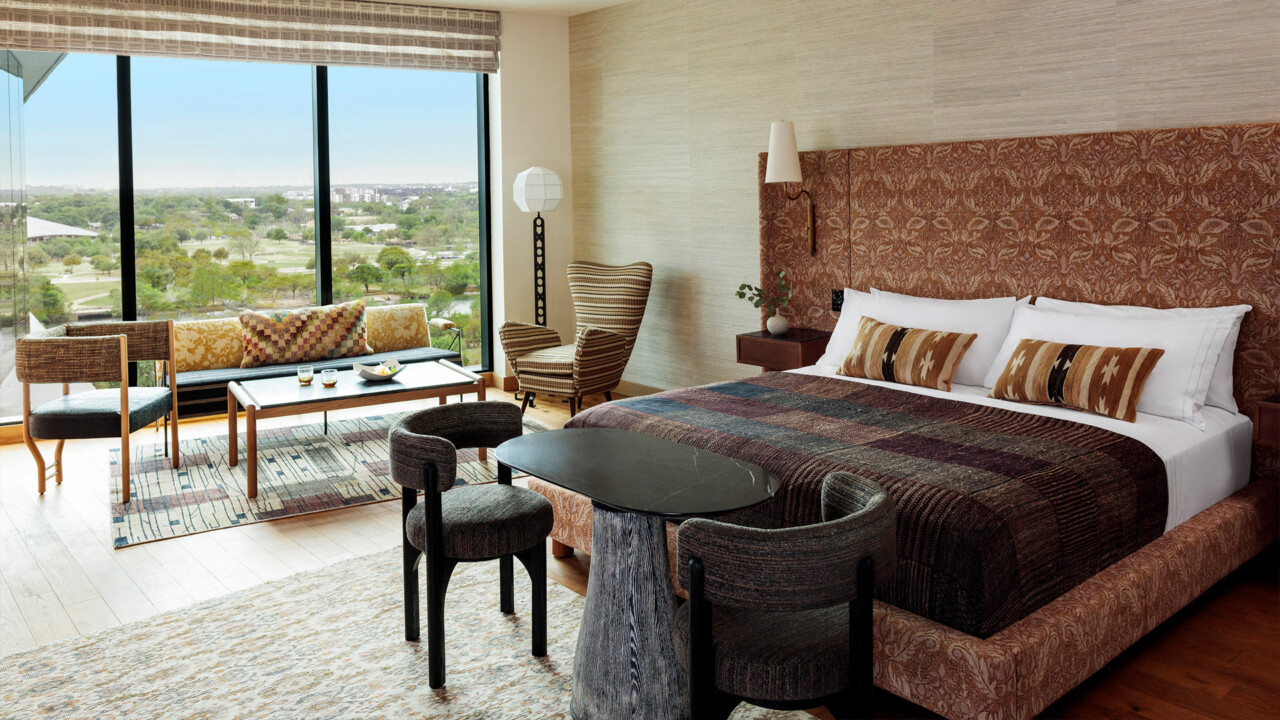 AUP roomSpacious hotel AUP room with a large bed, cozy seating area, and floor-to-ceiling window views