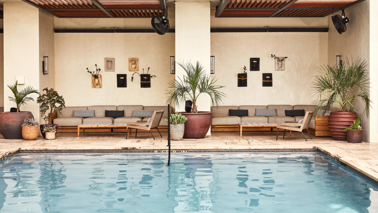 Stylish poolside lounge with seating and greenery