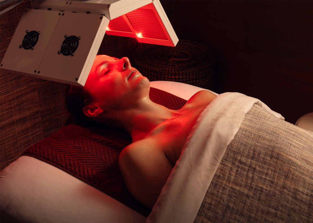Person receiving red light therapy in a spa setting