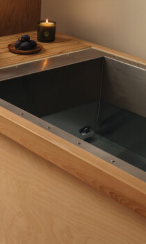 Wooden cold plunge tub with a minimalist spa setup