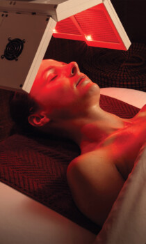 Person receiving red light therapy in a spa setting
