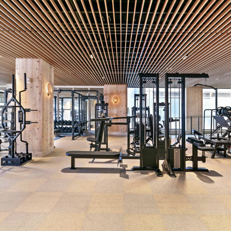 Modern luxury fitness center with strength training equipment and spacious wellness studio interior