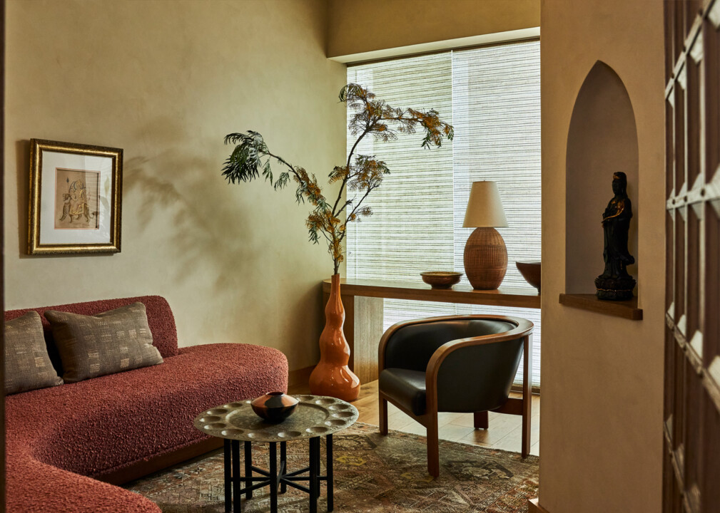 Cozy spa lounge with curved sofa, accent chair, and warm natural decor