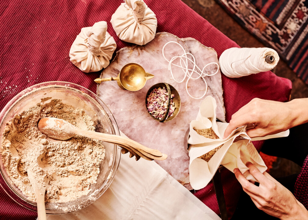 Spa preparation with herbal powders, bowls, and handmade wellness pouches