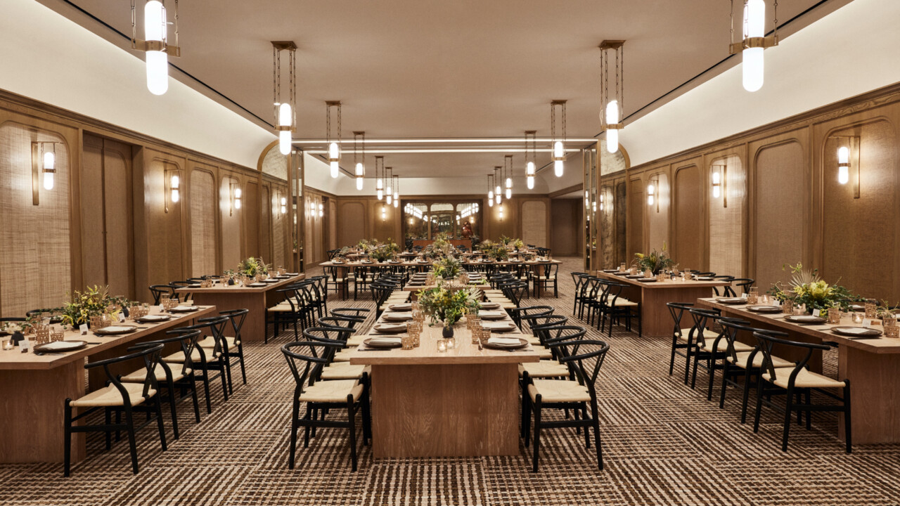 Modern ballroom venue with long banquet tables and elegant décor for corporate events, receptions, or private dinners