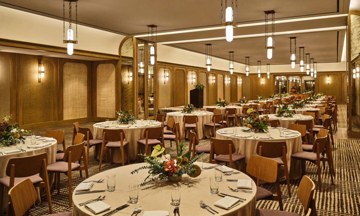 Elegant ballroom dining setup with floral centerpieces for luxury wedding or private event reception