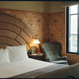 Cozy hotel bedroom with upholstered headboard and bedside lamps