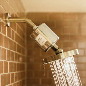 Filtered rainfall showerhead in a modern tiled wellness bathroom