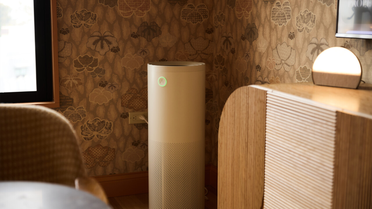 Air purifier in thoughtfully designed wellness hotel room with warm ambient lighting and textured interiors