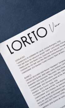 Wine menu from Loreto Vino featuring Italian and French wines, sparkling and white varieties, stylish black typography.