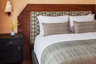 Contemporary guest room with warm wood accents and custom designer details