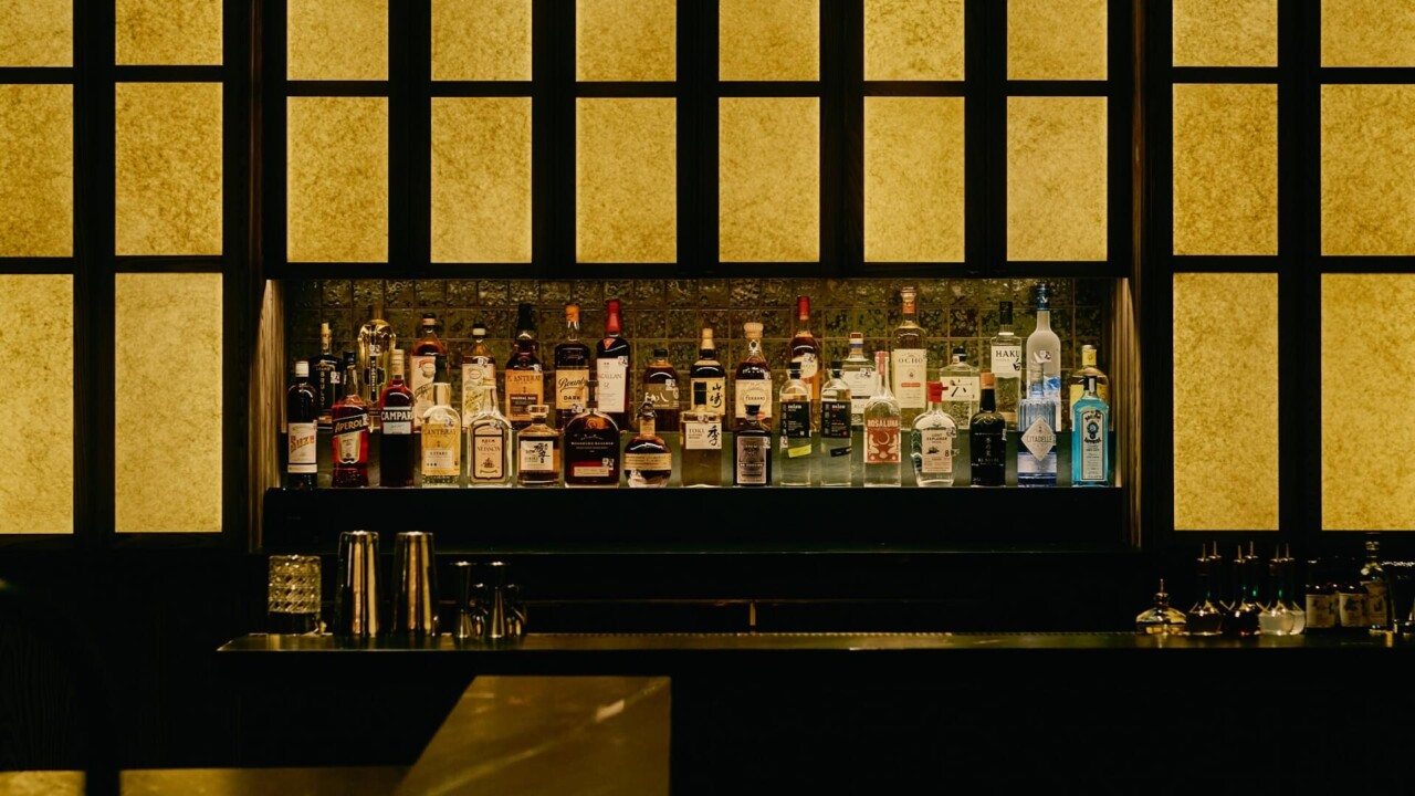 Moody, backlit bar with a curated selection of premium spirits.