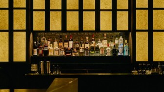 Moody, backlit bar with a curated selection of premium spirits.