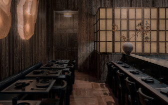 Intimate, wood-lined dining space with minimalist table settings and a serene, moody ambiance