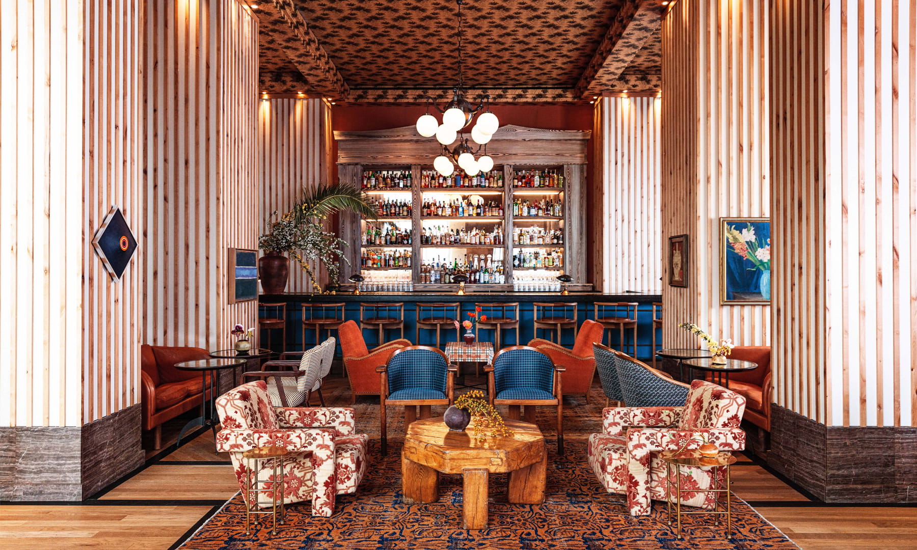Stylish lounge bar with warm tones and eclectic seating.