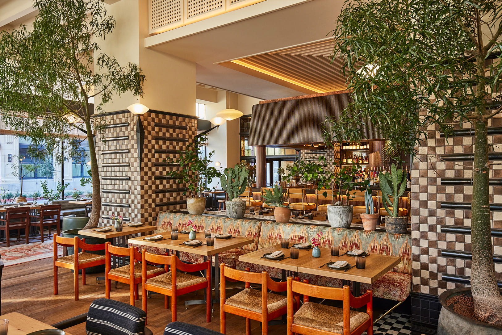 Bright and stylish dining space with lush greenery, artisan details, and contemporary California inspired design