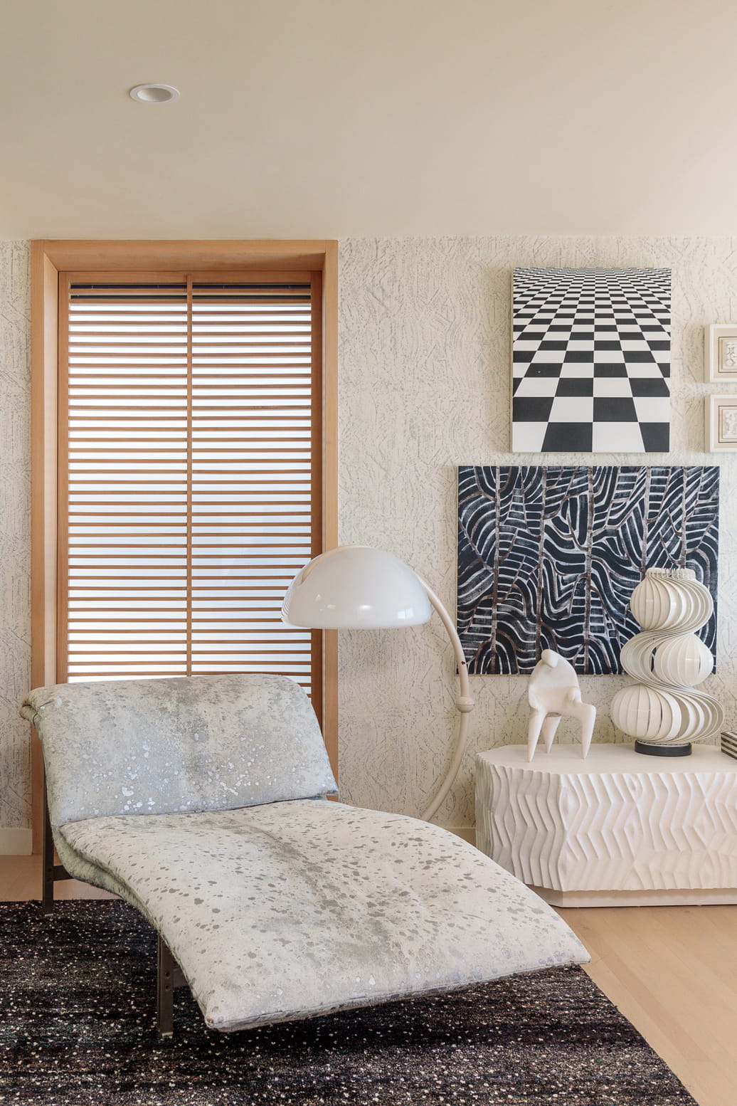 Large chair with decorative wall art and lamp