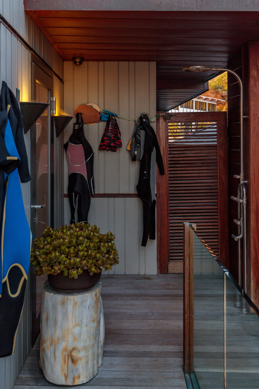 Outdoor shower with wet suits hanging