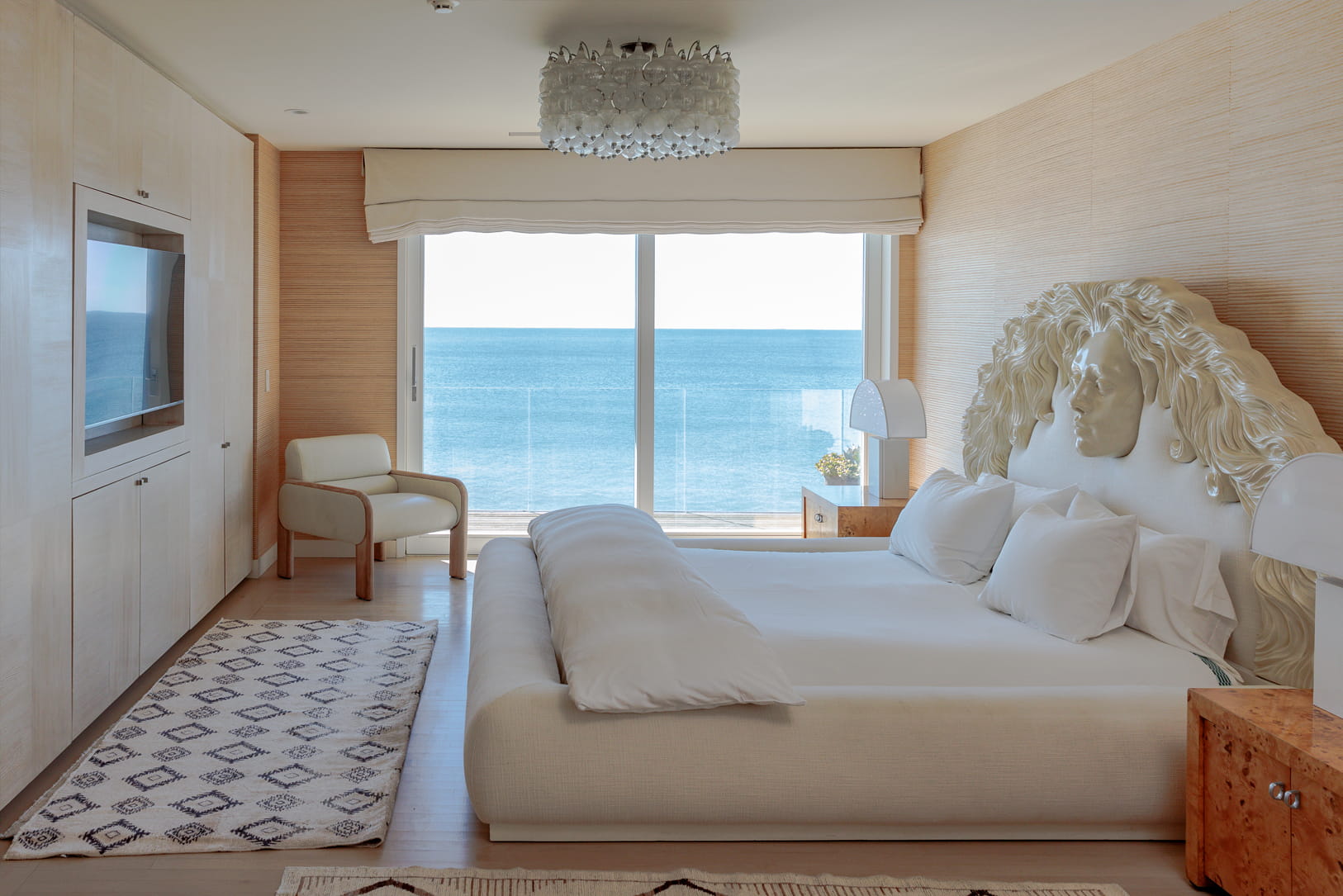 Ocean front bedroom with king bed, tv, and ocean front balcony