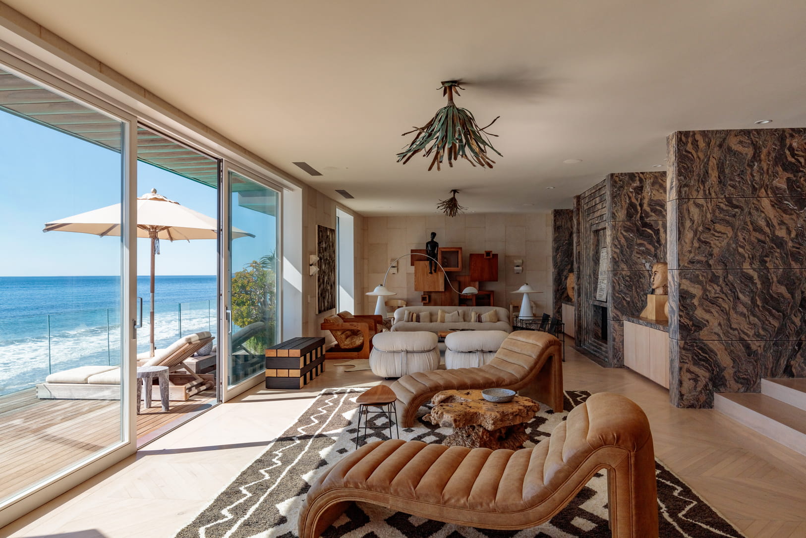 Malibu Beach House living space with two chairs facing beach front terrace