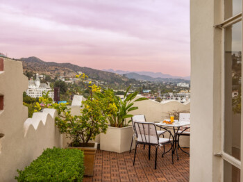 Scenic terrace with hillside views and cozy outdoor seating.